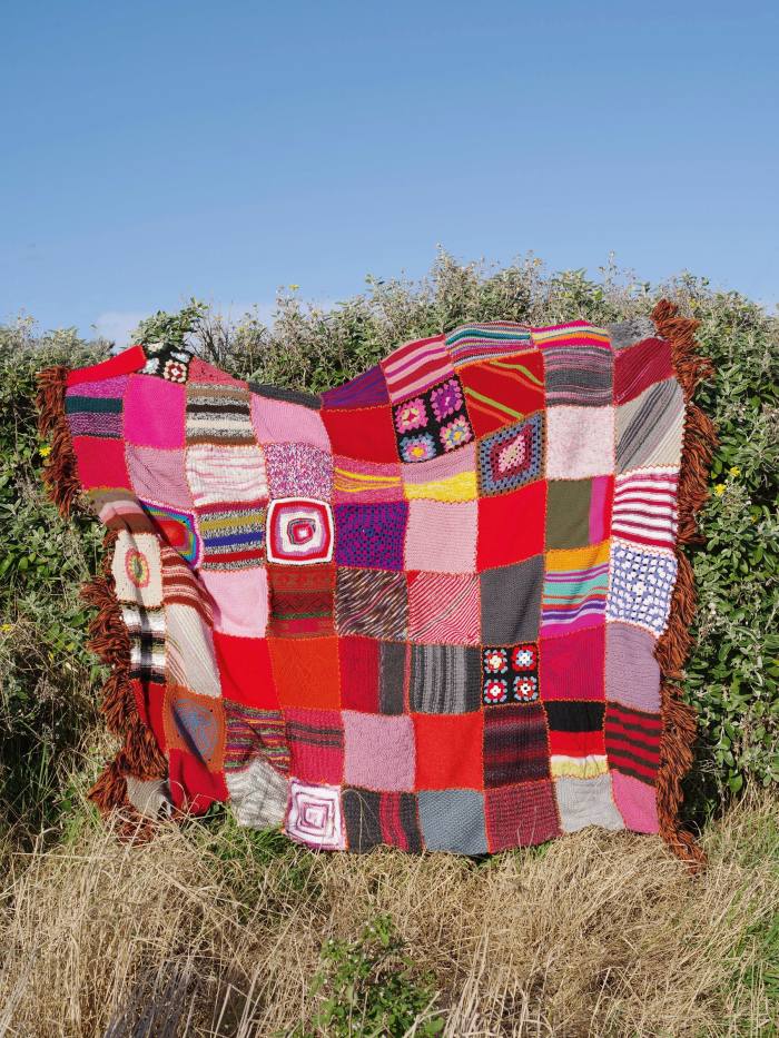 A handknitted blanket auctioned by Colville