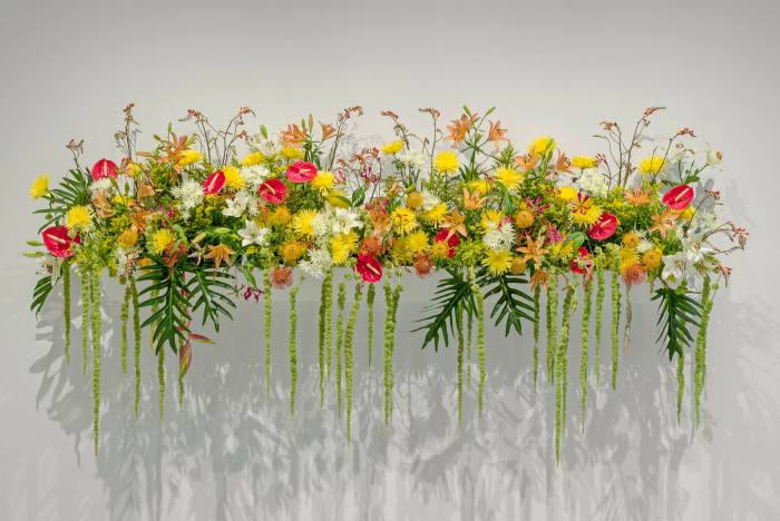 A long arrangement of yellow and red flowers
