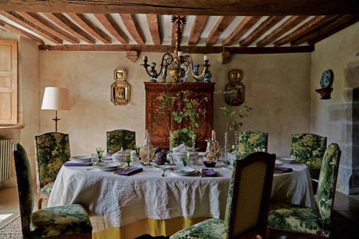 The dining-room table is laid with a Royal Copenhagen dinner service and antique glasses