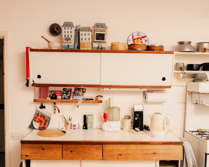 On top of the kitchen shelves is a cardboard animation set by Adrian’s wife Delphine Burrus next to a David Mellor pestle and mortar 