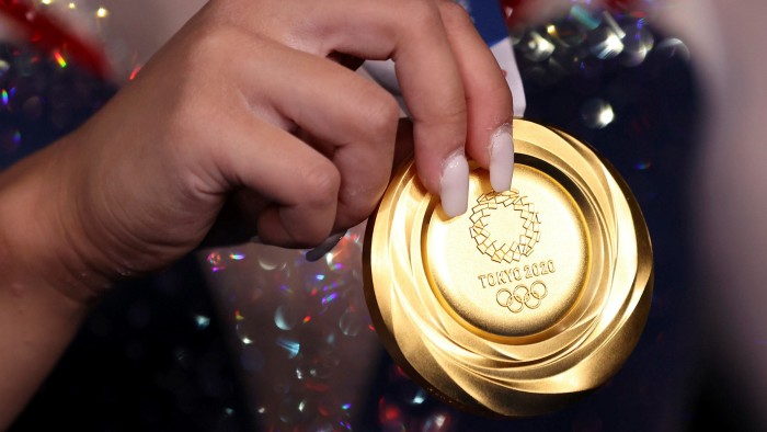 Gold standard: Sunisa Lee displays her winner’s medal from the Tokyo Games