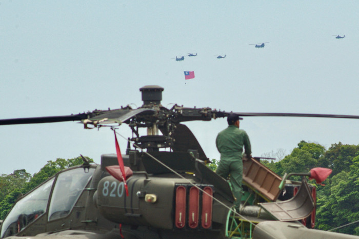 A Taiwanese soldier with a US-made Apache attack helicopter at a military base in Taoyuan 
