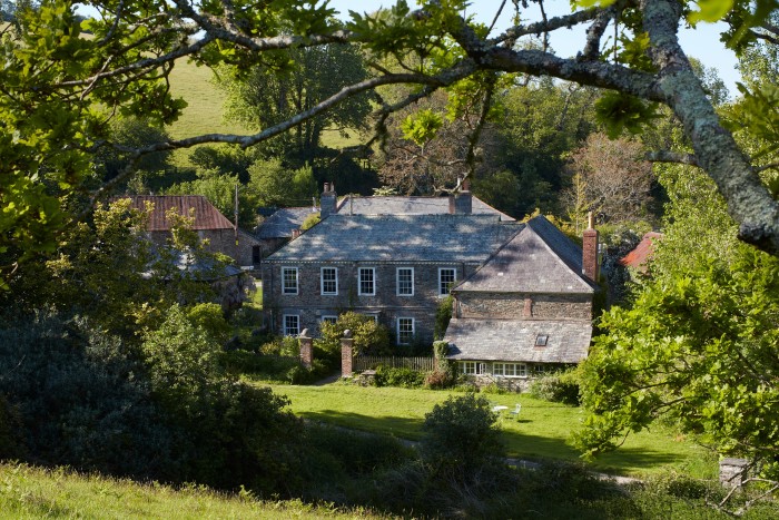 The house is a former dairy farm in a steep south Devon valley