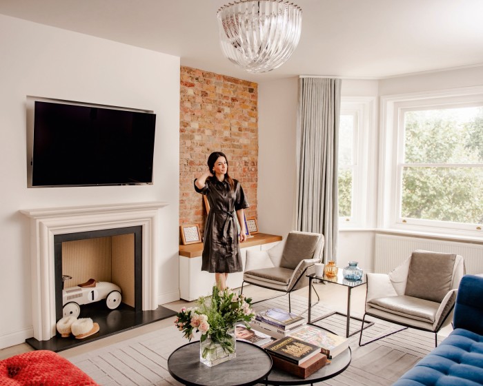 Hakim in her favourite room in her home – the living room, with its electric-blue Roche Bobois sofa