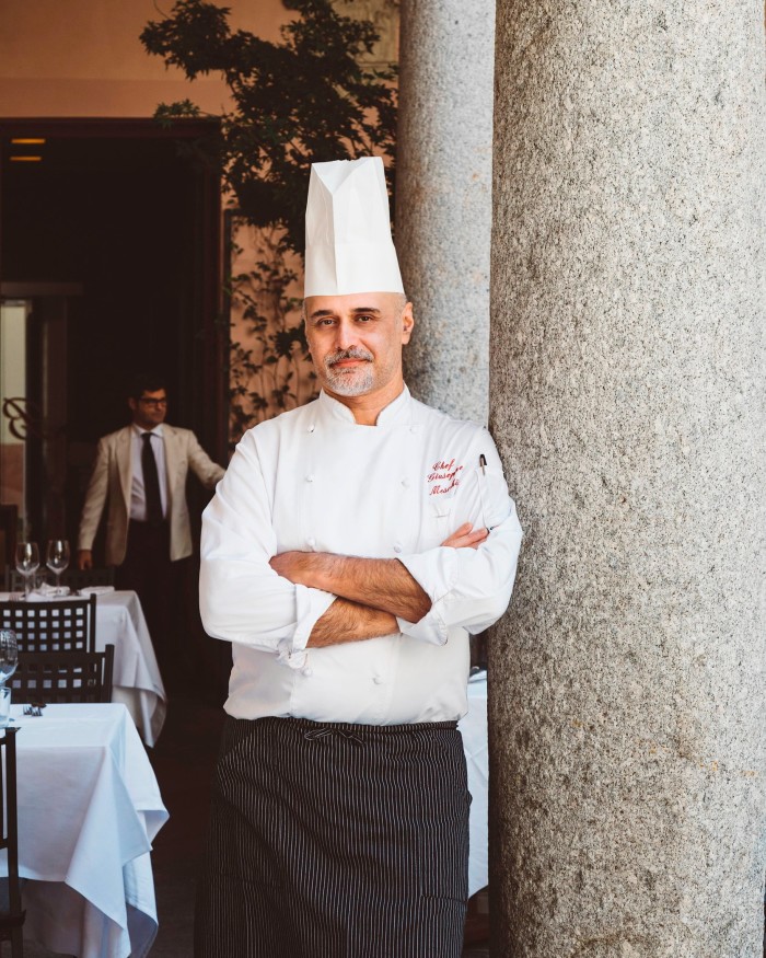 The restaurant’s chef, Giuseppe Meschino, leaning against a granite column