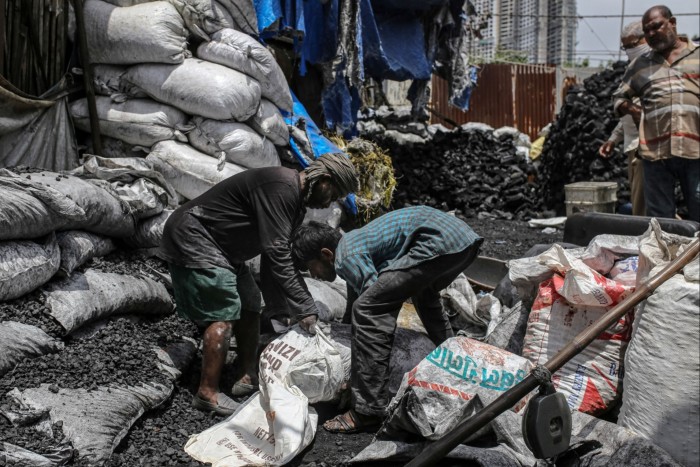 workers loading coals into sacks
