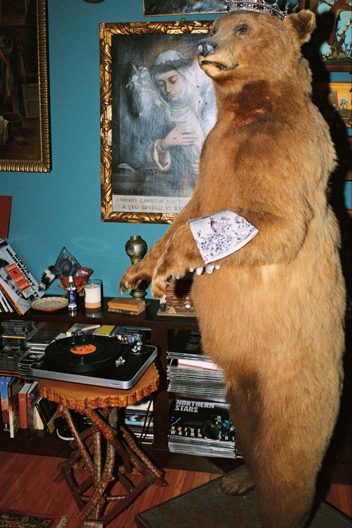 The turntable given to him by his husband, beside “the DJ”, a second-hand taxidermy bear