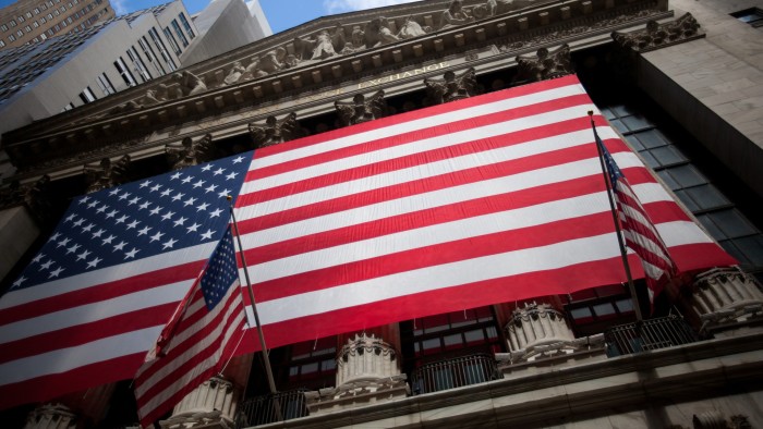 An American flag is displayed on the exterior of the New York Stock Exchange