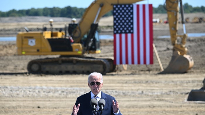 Joe Biden speaks while visiting a construction site