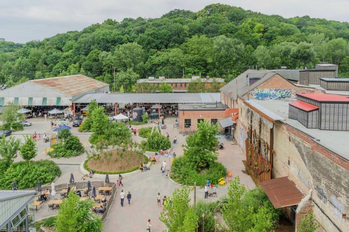 Buildings and a courtyard dotted with trees at Toronto’s Evergreen Brick Works