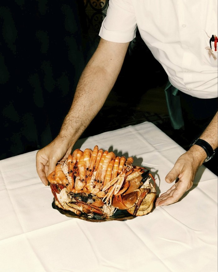 A seafood platter held by a member of staff at Ribeira do Miño