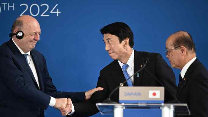 Italy’s environment minister Gilberto Pichetto Fratin, left, shakes hands with Japanese economy minister Ken Saito at the G7 climate meeting in Turin on Tuesday