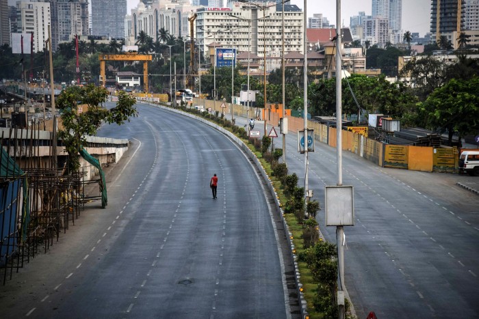 A man walks along a near-deserted street during a lockdown in April this year in Mumbai