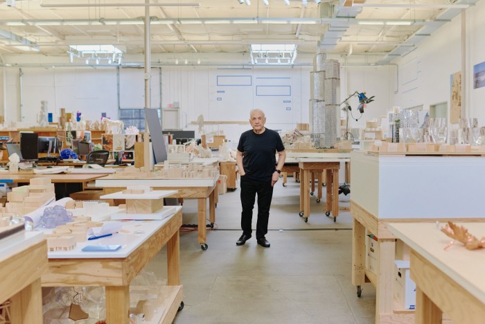 Gehry walks among the design models in his studio