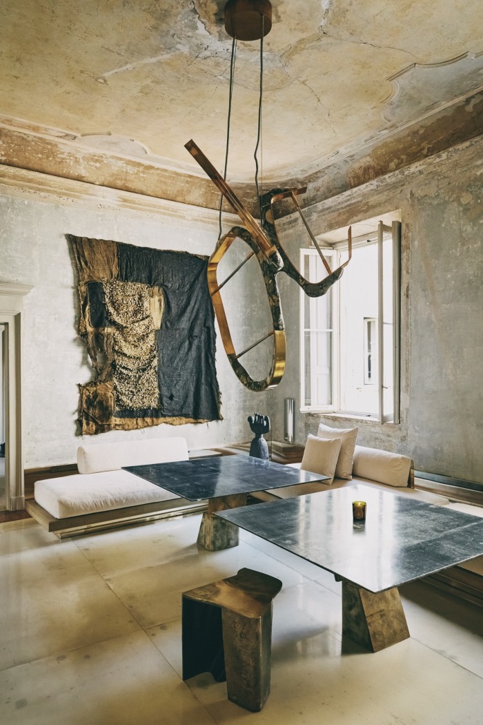 A marble and cast-brass chandelier by de Cotiis dominates the living room