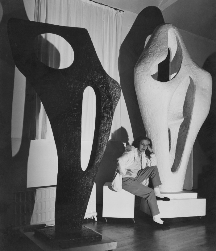Left: Barbara Hepworth photographed in 1964 with Figure For Landscape in plaster and a bronze cast of Figure (Archaean)