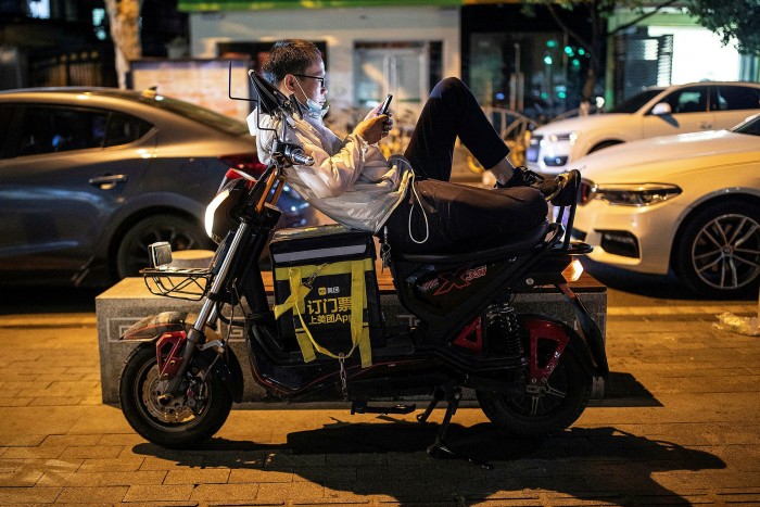 A Chinese delivery rider waits for orders in Wuhan