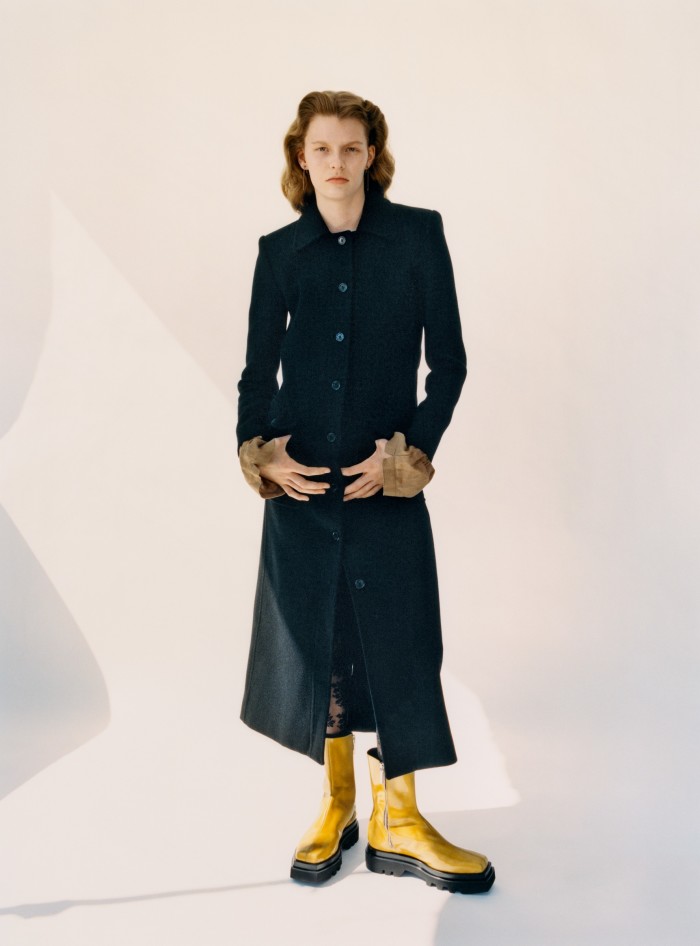Saint Laurent by Anthony Vaccarello wool jersey coat, £2,270. Peter Do viscose Flowers top (cuffs showing), £327, and leather boots, £765. Calzedonia lace tights, £13. Earrings, stylist’s own