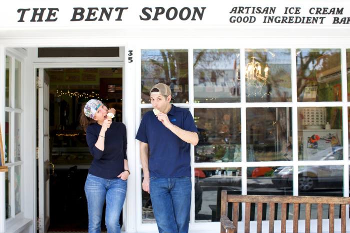 A man and woman eat ice cream outside The Bent Spoon in Princeton