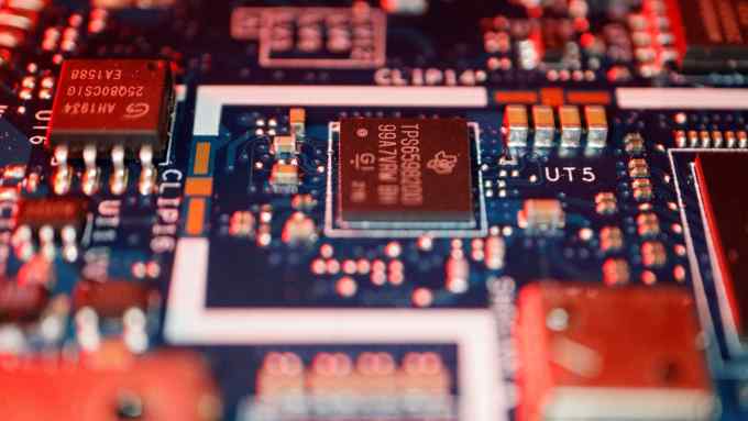 Semiconductor chips are seen on a circuit board of a compute