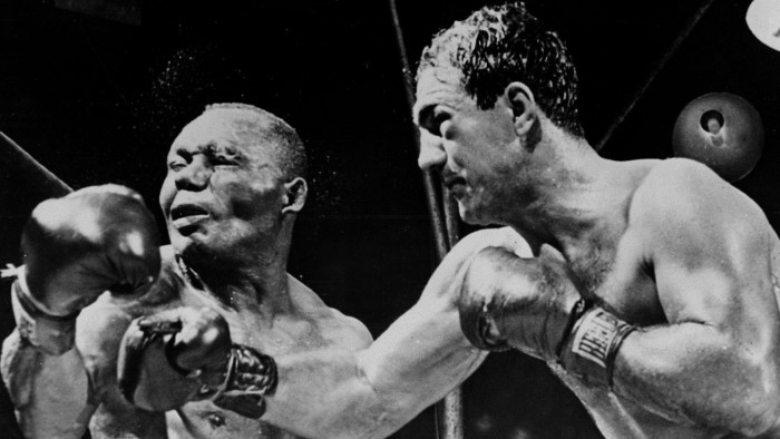 American boxing champion Rocky Marciano, right, throws a right swing to his country fellow heavyweight boxing world champion Joe Walcott in New York on September 1952 