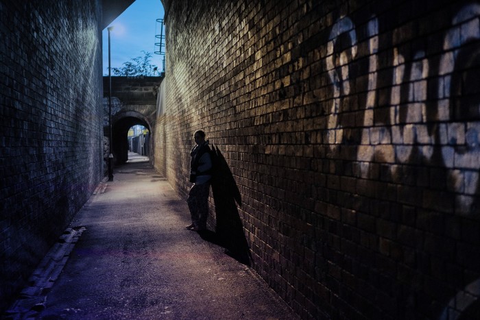 A woman standing in the alley of a legalised prostitution zone in Holbeck, Leeds