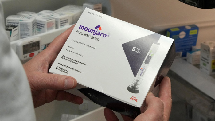 Person holds a box of Mounjaro injection drug
