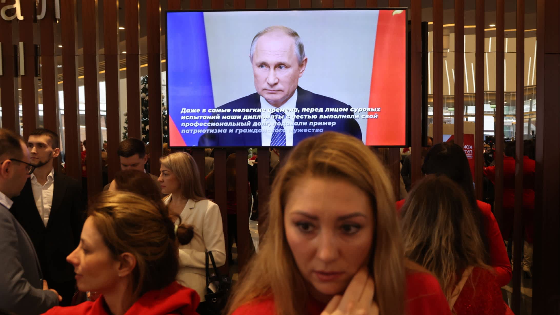 Russia’s Vladimir Putin appears on a big screen in front of supporters in December 2023