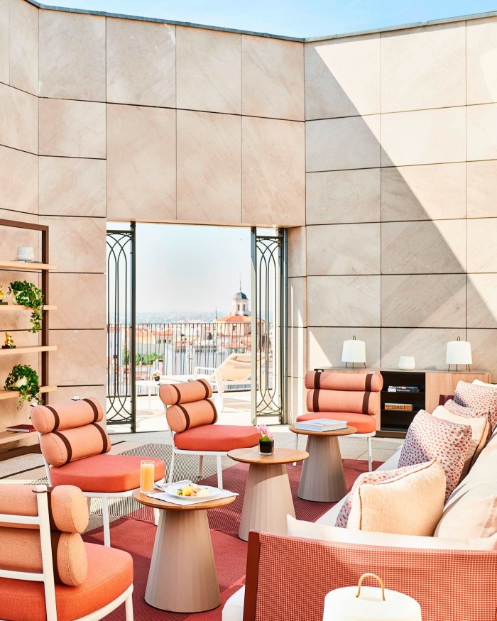 Chairs and sofas in an open-air room in the Four Seasons Madrid’s spa