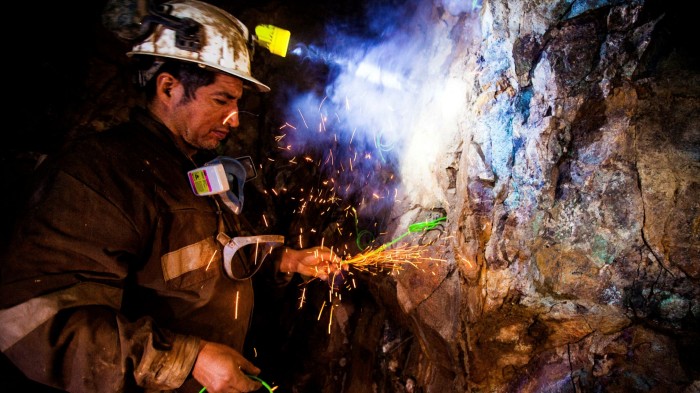 A miner places explosives inside the Kiara copper mine in Chile