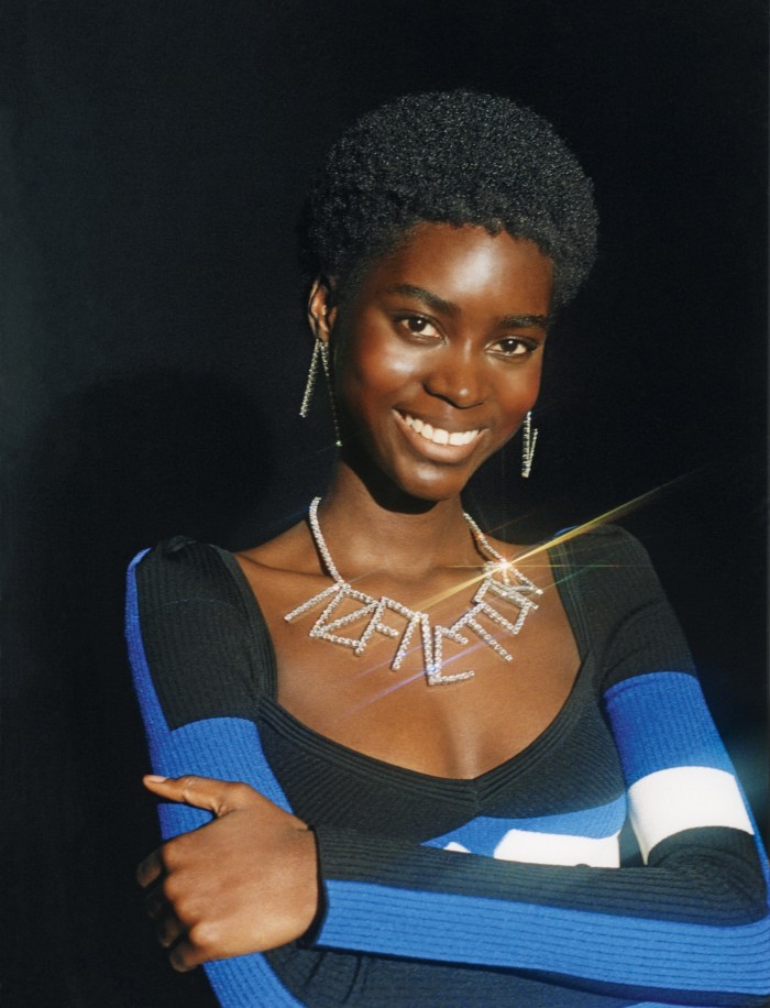 Tomiwa wears AZ Factory viscose, Lycra and polyester puff-shoulder MyBody 2.0 dress, £1,200, brass, aluminium and glass Crystal earrings, £410, and brass and glass Crystal necklace, £830