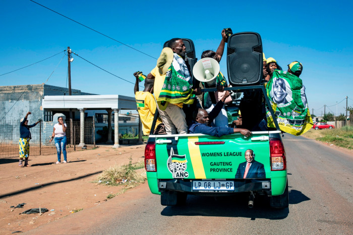 A convoy of ANC supporters drive down a road in Ekurhuleni, Gauteng
