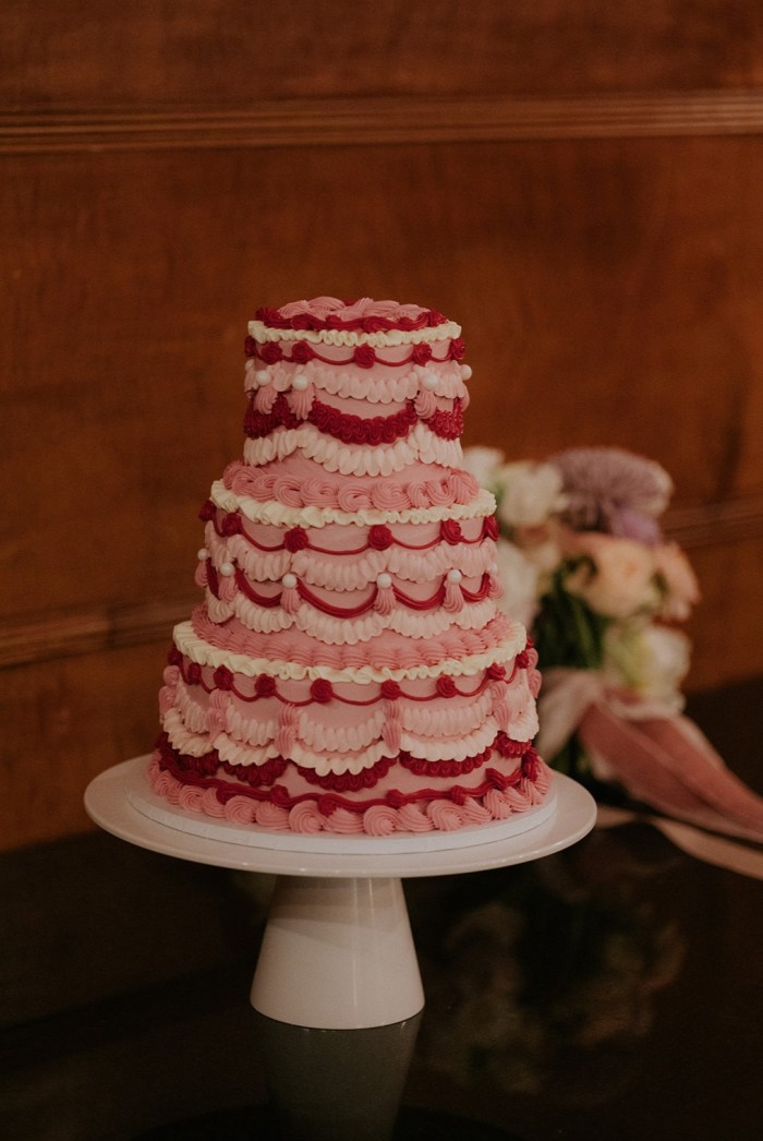 Multi-tiered raspberry compote and white chocolate buttercream cake with retro piping by Olivia Hill