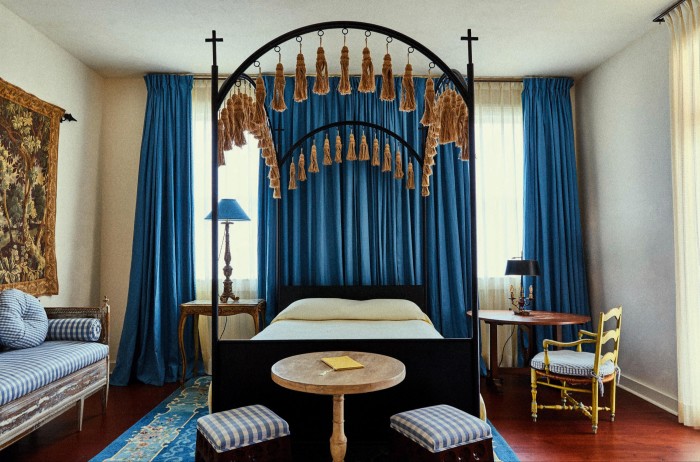 A Convent Guest Room with wrought-iron four-poster bed, designed by hotelier and interior design firm Ash, at Hotel Peter & Paul in New Orleans