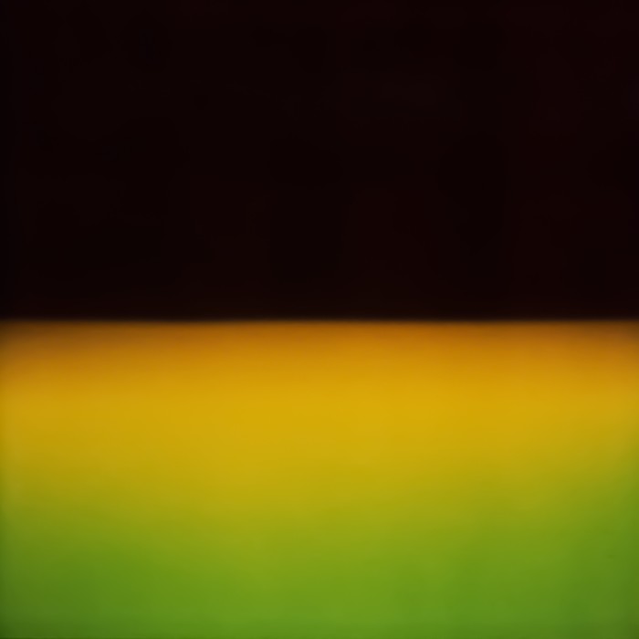 An abstract image is divided into a top black swathe and a gradient yellow-to-green bottom one