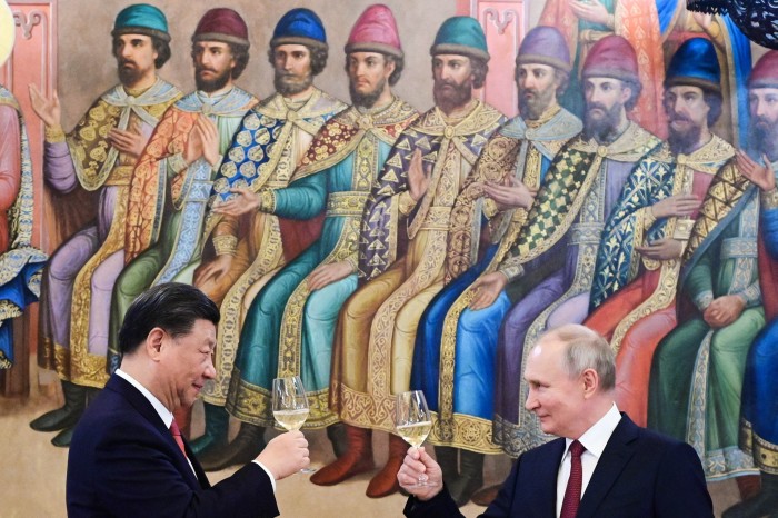 Russian President Vladimir Putin and China’s President Xi Jinping make a toast during a reception following their talks at the Kremlin in Moscow on March 21, 2023