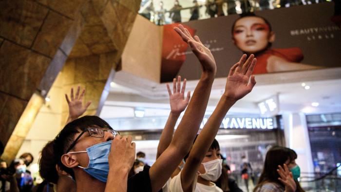 Anti-government protesters sing the protest anthem ‘Glory to Hong Kong’ at a shopping mall in Hong Kong in May 2020