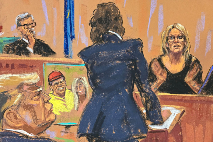 A courtoom sketch of Stormy Daniels testifying as Donald Trump looks on 