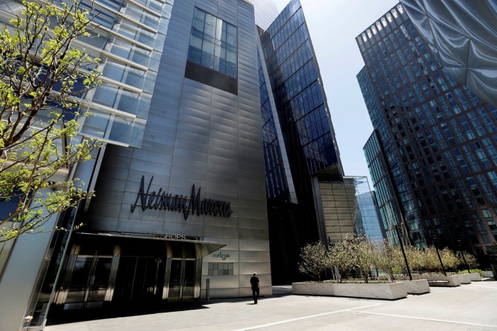 A man walks past the Neiman Marcus store, which has filed for bankruptcy, at Hudson Yards