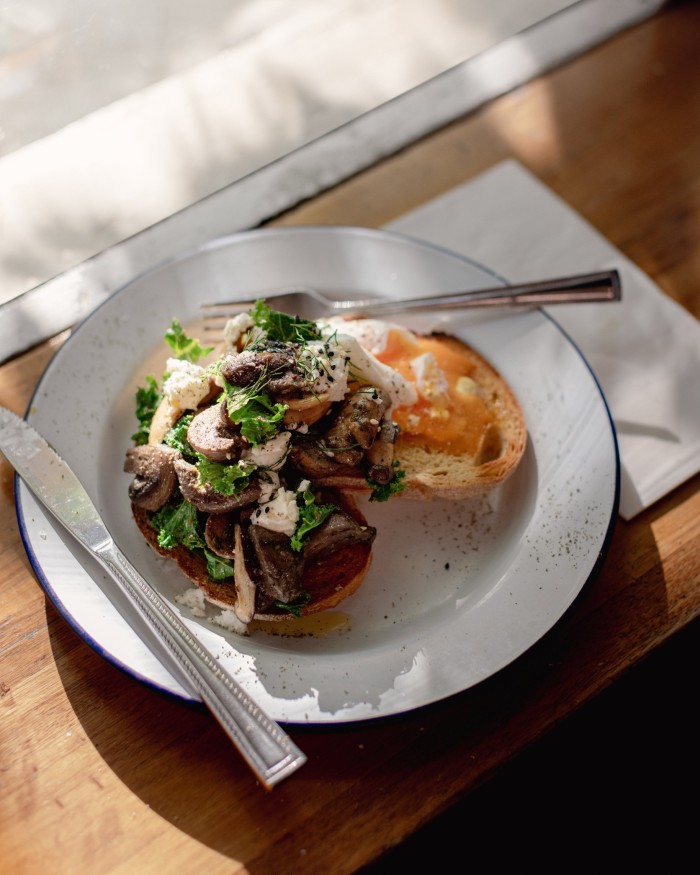 A plate of “Magic” mushrooms on toast with kale, locally sourced goat’s cheese and miso at Captains of Industry