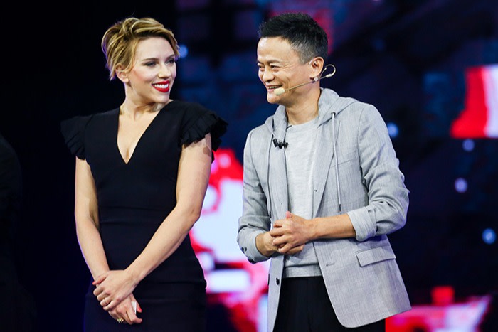 Jack Ma stands on stage next to actress Scarlett Johansson at a promotion for an online shopping festival in Shenzhen in 2016. Both are smiling