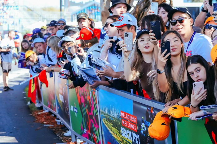 Fans at the sidelines, some holding mobile phones, at the 2022 Australian Formula 1 Grand Prix 