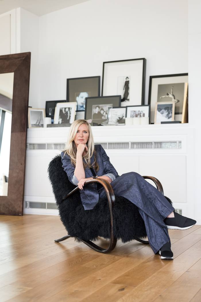Amanda Wakeley on one of her pair of lambskin chairs by Jindrich Halabala
