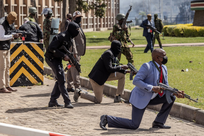Armed police officers and security personnel take position to protect the Kenyan parliament