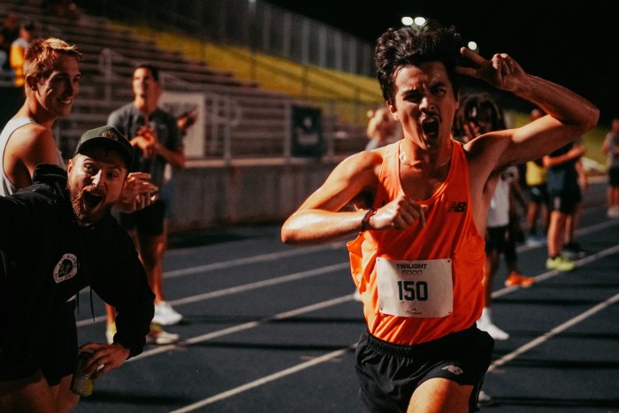 A triumphant runner at Tracksmith’s Twilight 5,000 race in Ann Arbor, Michigan
