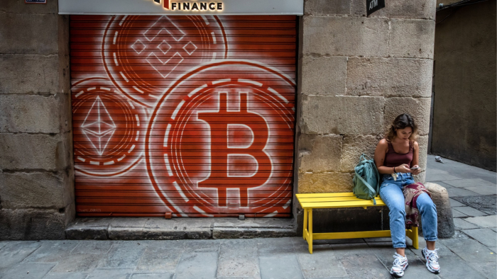 Logos for Ethereum, left, Binance Coin, top, and Bitcoin on the shutters of a cryptocurrency exchange in Barcelona
