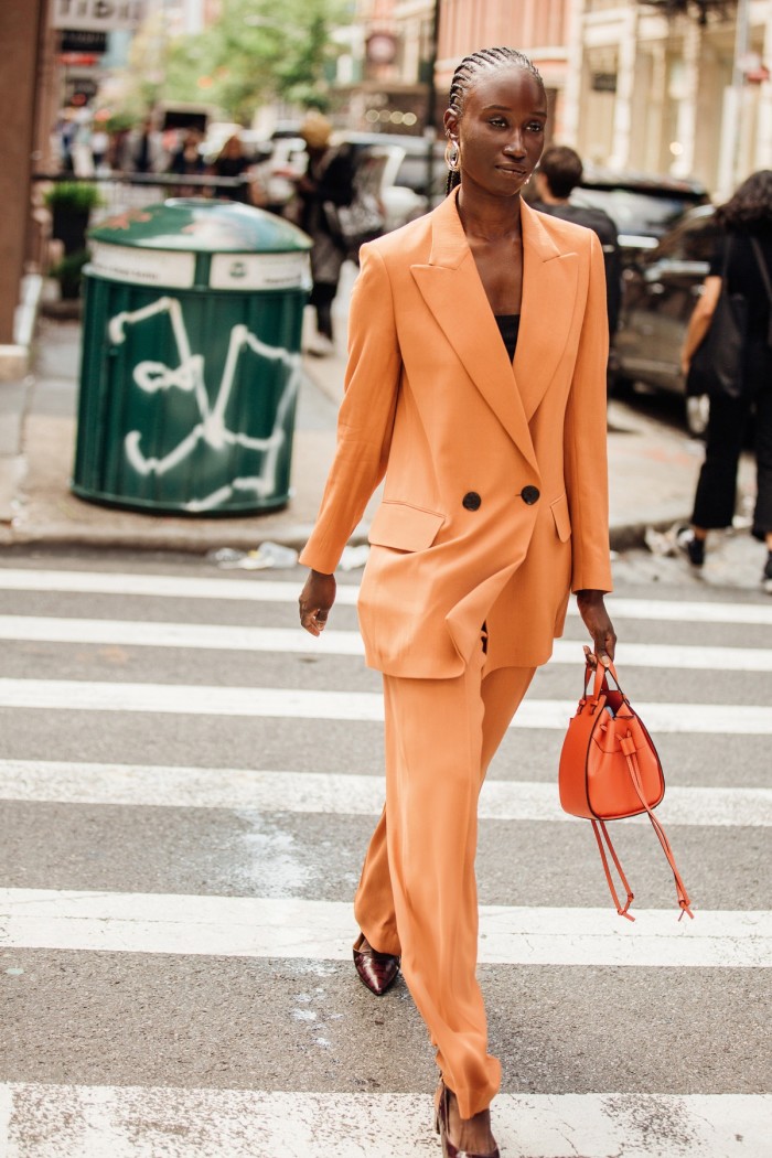 Amy Sall wears a Petar Petrov jacket and trousers with a Loewe bag