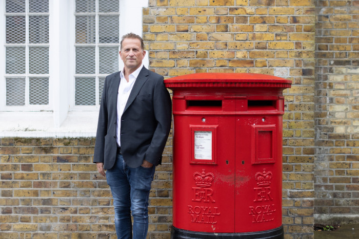Councillor Mark Shooter stands next to post box in Hendon