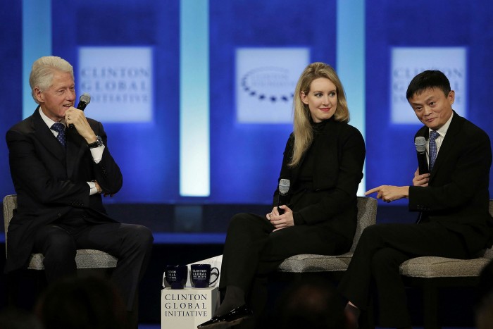 Former US President Bill Clinton (L) and Theranos Founder and CEO Elizabeth Holmes listen as Alibaba Group Executive Chairman Jack Ma (R) speaks during the Clinton Global Initiative annual meeting in New York
