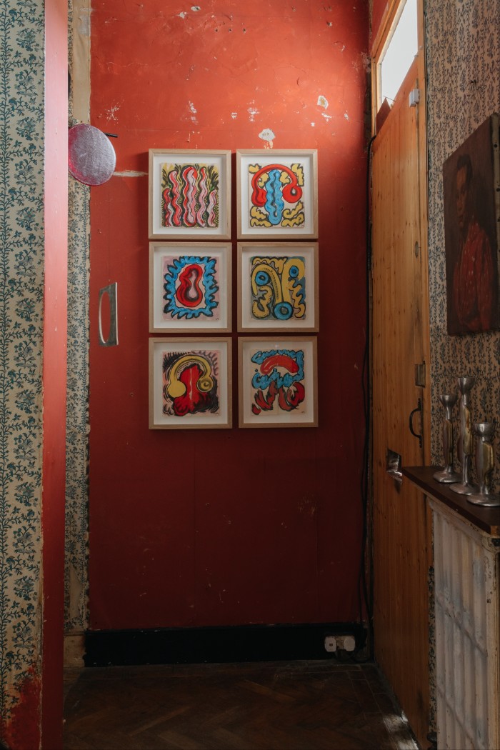 The entrance, with paintings by Christabel MacGreevy, a mobile by Daniel Reynolds, portrait by Ron Hitchins and Atelier LK Collection candlesticks by David Marshals